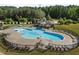 Community pool with clear blue water, surrounded by lounge chairs and a gazebo, perfect for summer relaxation at 212 Crisp Rd, Durham, NC 27713