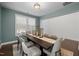 Elegant dining room with a modern table setting, large windows, and soft, neutral wall colors at 212 Crisp Rd, Durham, NC 27713