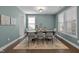 Well-lit dining room with a dark wood table, six chairs, and neutral-toned decor creating an inviting atmosphere at 212 Crisp Rd, Durham, NC 27713