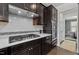 Close-up of kitchen featuring stainless steel appliances, tile backsplash, and a gas cooktop on white countertops at 212 Crisp Rd, Durham, NC 27713