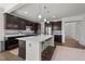 Spacious kitchen with dark wood cabinets, quartz countertops, an island, and modern stainless steel appliances at 212 Crisp Rd, Durham, NC 27713
