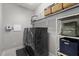 Modern laundry room with black washer and dryer, shelving, and storage for your laundry needs at 212 Crisp Rd, Durham, NC 27713