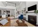 Open-concept living room with high ceilings, gas fireplace, and access to the kitchen and staircase at 212 Crisp Rd, Durham, NC 27713