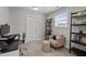 Functional office space with a window, shelving unit, and a cozy chair at 212 Crisp Rd, Durham, NC 27713