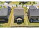 Aerial view of a fenced backyard with a covered patio and green lawn at 214 Dogwood Blossoms Dr, Durham, NC 27703