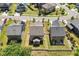 Aerial view of the backyard with a patio, white picket fence, and lush grass at 214 Dogwood Blossoms Dr, Durham, NC 27703