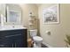 Charming powder room with stylish vanity, decorative mirror, and tasteful accents at 214 Dogwood Blossoms Dr, Durham, NC 27703
