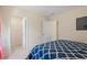 View of a bedroom and the open doorway into the walk-in closet with wire shelving at 214 Dogwood Blossoms Dr, Durham, NC 27703