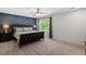 Large bedroom with a king bed, blue accent wall, and carpet flooring at 214 Dogwood Blossoms Dr, Durham, NC 27703