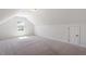 Finished bonus room under slanted ceiling with a carpeted floor and white walls at 214 Dogwood Blossoms Dr, Durham, NC 27703