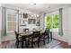 Bright dining room featuring modern decor, large windows, and comfortable seating for six at 214 Dogwood Blossoms Dr, Durham, NC 27703