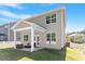 Back of home featuring a covered outdoor patio, manicured lawn, and vinyl siding at 214 Dogwood Blossoms Dr, Durham, NC 27703