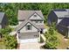 Charming two-story home featuring a two-car garage, landscaped front yard, and classic architectural details at 214 Dogwood Blossoms Dr, Durham, NC 27703