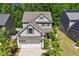 Inviting two-story home featuring an attached two-car garage, lush landscaping, and a well-maintained lawn at 214 Dogwood Blossoms Dr, Durham, NC 27703
