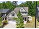 Beautiful two-story home boasts a manicured lawn, attached garage, and inviting front porch at 214 Dogwood Blossoms Dr, Durham, NC 27703