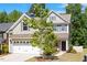 Two-story home with a well-manicured front lawn, a two-car garage, and a welcoming entrance at 214 Dogwood Blossoms Dr, Durham, NC 27703