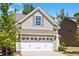 A close-up of a two-car garage, offering plenty of room for vehicles and storage, attached to the house at 214 Dogwood Blossoms Dr, Durham, NC 27703