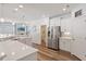 Bright and airy kitchen featuring stainless steel appliances, quartz countertops, and ample cabinet space at 214 Dogwood Blossoms Dr, Durham, NC 27703