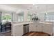 Modern kitchen with quartz countertop, stainless steel appliances and open to dining area at 214 Dogwood Blossoms Dr, Durham, NC 27703