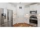 Kitchen with stainless steel appliances, white cabinets and quartz countertops at 214 Dogwood Blossoms Dr, Durham, NC 27703