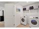 Convenient laundry room with a washer and dryer and shelving with storage at 214 Dogwood Blossoms Dr, Durham, NC 27703