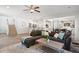 An open living space with hardwood floors, stylish seating, and views to the kitchen, stairs, and dining area at 214 Dogwood Blossoms Dr, Durham, NC 27703