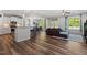 Open concept living space showcasing hardwood floors, natural light, and views of the kitchen and dining area at 214 Dogwood Blossoms Dr, Durham, NC 27703
