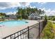 Community pool with lounge chairs and nearby clubhouse, surrounded by trees at 214 Dogwood Blossoms Dr, Durham, NC 27703