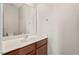 Bathroom featuring single sink, mirror and wood cabinets at 235 Michigan Ave, Cary, NC 27519