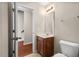 Well-lit half bathroom featuring a vanity with storage and neutral wall paint at 235 Michigan Ave, Cary, NC 27519
