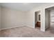 Neutral bedroom boasts carpet floors and two doors to other rooms at 235 Michigan Ave, Cary, NC 27519