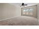 Spacious bedroom featuring neutral paint, ceiling fan, and large window at 235 Michigan Ave, Cary, NC 27519