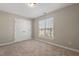 Carpeted bedroom with window and closet at 235 Michigan Ave, Cary, NC 27519