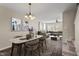 Open-concept dining area with modern lighting and elegant table, flowing into the living room at 235 Michigan Ave, Cary, NC 27519