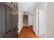Inviting foyer with hardwood floors, leading to carpeted stairs and interior doors at 235 Michigan Ave, Cary, NC 27519