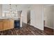 Open concept kitchen with granite countertops, breakfast bar, and wood-look floors at 235 Michigan Ave, Cary, NC 27519