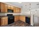 Bright kitchen featuring stainless appliances, breakfast bar, and wood-look floors at 235 Michigan Ave, Cary, NC 27519