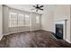 Inviting living room featuring dark wood-look floors, fireplace and many windows at 235 Michigan Ave, Cary, NC 27519
