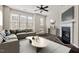 Bright living room featuring hardwood floors, modern ceiling fan and a cozy fireplace at 235 Michigan Ave, Cary, NC 27519