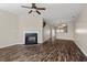 Spacious living room with dark wood-look flooring, fireplace, and ceiling fan at 235 Michigan Ave, Cary, NC 27519