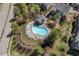 Aerial view of a community pool with lounge chairs surrounded by trees at 235 Michigan Ave, Cary, NC 27519