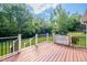 Inviting back deck with black railings offers a relaxing outdoor space with views of the lush, green backyard at 2457 Millbrook Dr, Haw River, NC 27258