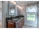Bathroom featuring a dual vanity with granite countertops, decorative mirrors, and tiled floors at 2457 Millbrook Dr, Haw River, NC 27258