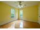 Spacious bedroom featuring hardwood floors and lots of natural light from two windows at 2457 Millbrook Dr, Haw River, NC 27258