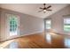Large bedroom with hardwood floors, vaulted ceilings, a ceiling fan and access to a porch at 2457 Millbrook Dr, Haw River, NC 27258