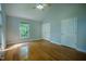 Light-filled bedroom with vaulted ceiling, hardwood floors, and a large window at 2457 Millbrook Dr, Haw River, NC 27258