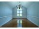 Bright dining room with hardwood floors, decorative trim, and elegant chandelier at 2457 Millbrook Dr, Haw River, NC 27258