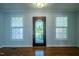 Bright entryway featuring hardwood floors, natural light, and a decorative door at 2457 Millbrook Dr, Haw River, NC 27258
