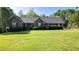 Charming brick home featuring manicured landscaping and a sprawling green lawn at 2457 Millbrook Dr, Haw River, NC 27258