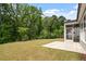 A view of the back yard showing a screened in porch and grassy area at 2650 Turner Pines Dr, New Hill, NC 27562